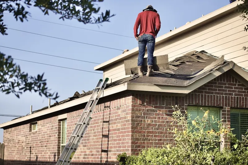 Professional roofer working on a residential roof in Cool